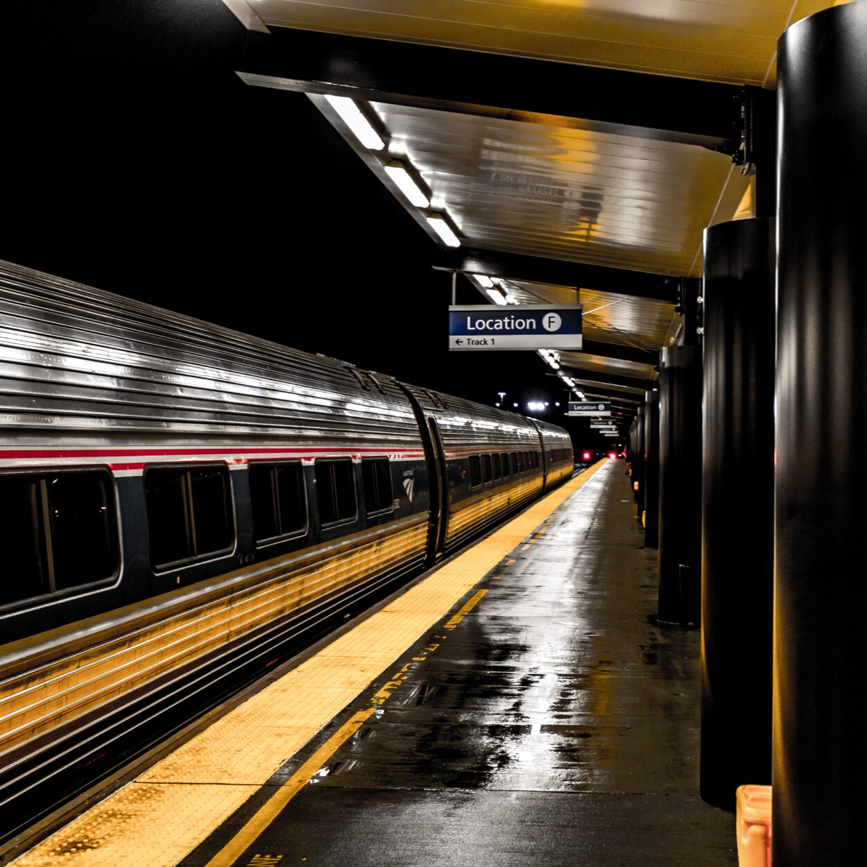 Train passing by a platform at a train station