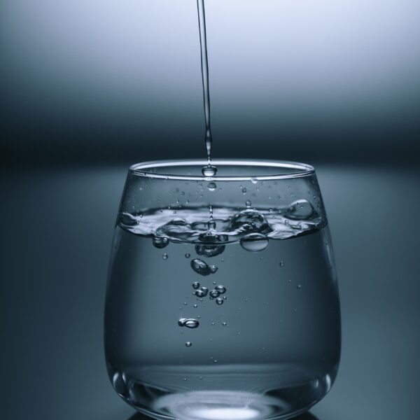 clear drinking glass on gray surface