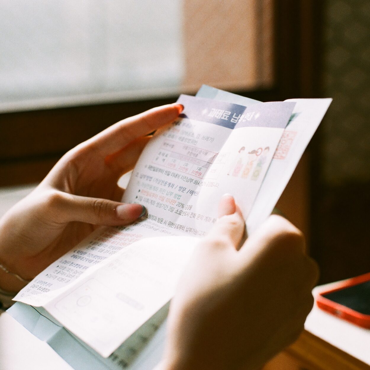 person holding white printer paper