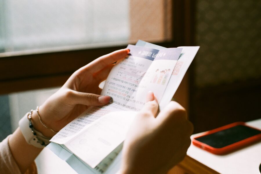 person holding white printer paper